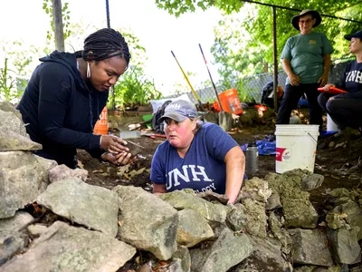 Researchers Kabria Baumgartner and Meghan Howey at the dig site