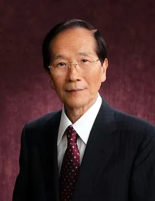 a photograph portrait of Akira Endo on a red background