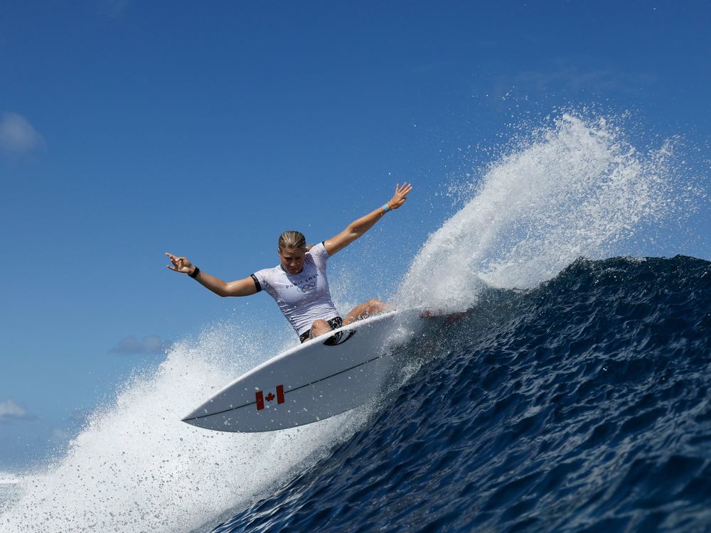 Woman surfing a big wave