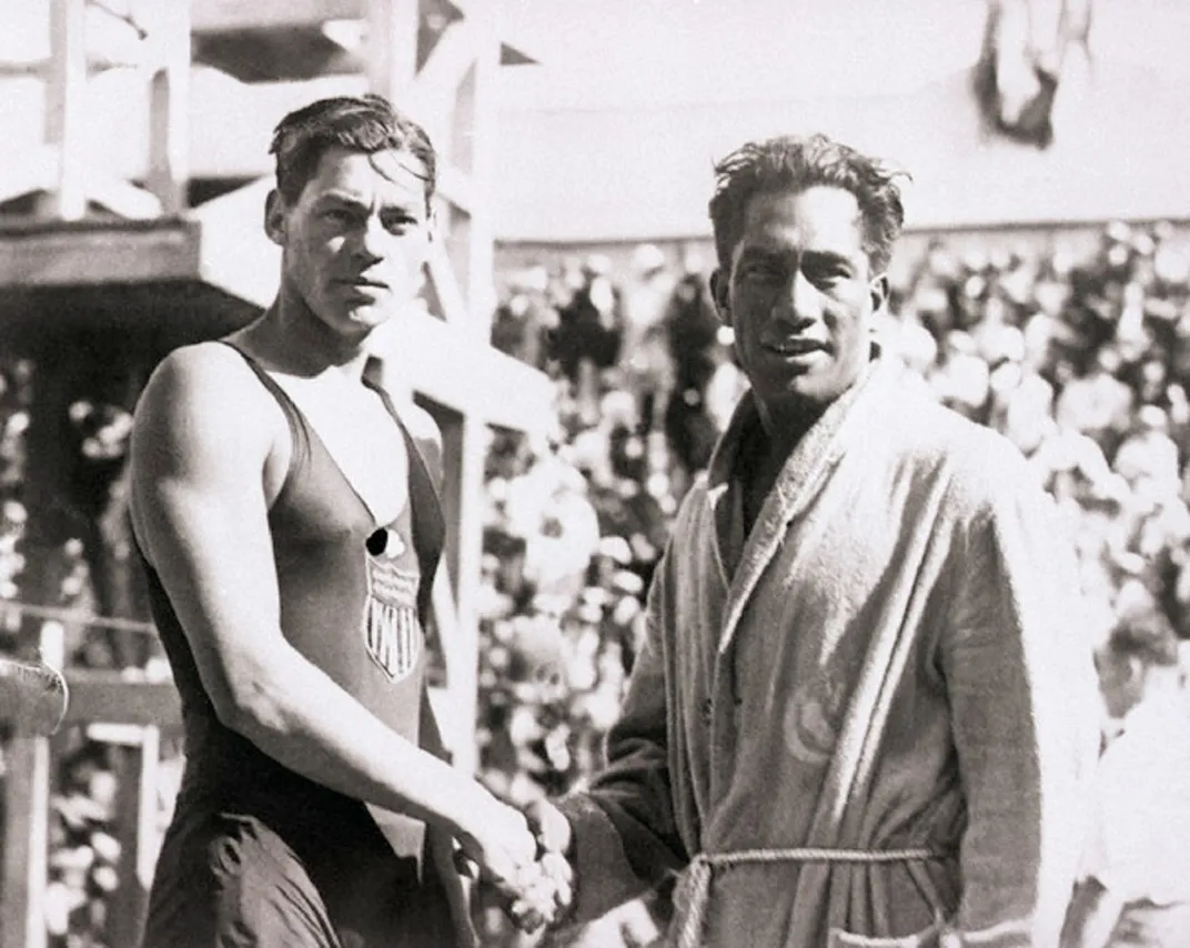 Weissmuller (left) shakes hands with fellow Olympian Duke Kahanamoku in 1924.