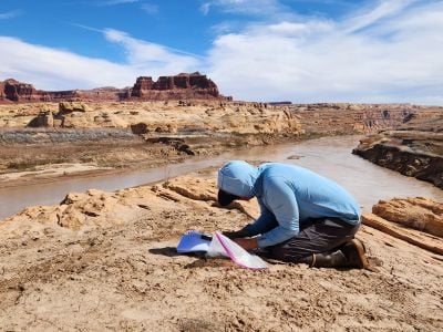 Returning Rapids Project investigator Chris Benson examines old photos of the Colorado River to see how it has changed over time.