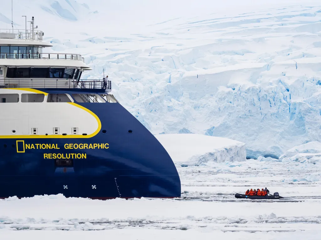 A zodiac returns to Lindblad's Resolution at Peterman Island in Antarctica